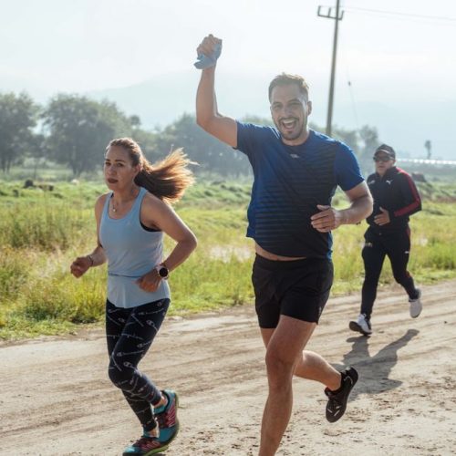 Group of people enjoying a morning run on a rural trail, embracing fitness and vitality.
