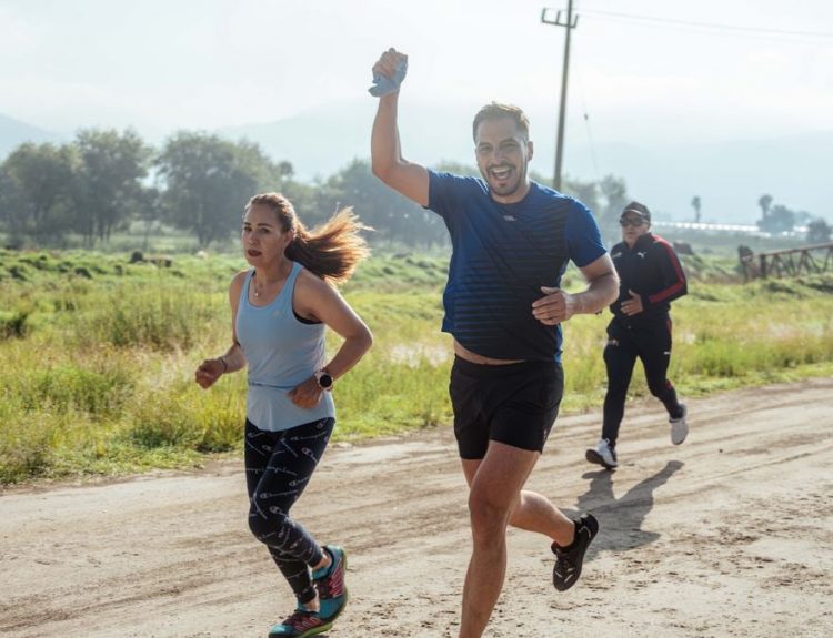 Group of people enjoying a morning run on a rural trail, embracing fitness and vitality.